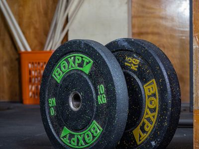 Weights and plates stacked in a modern gym corner